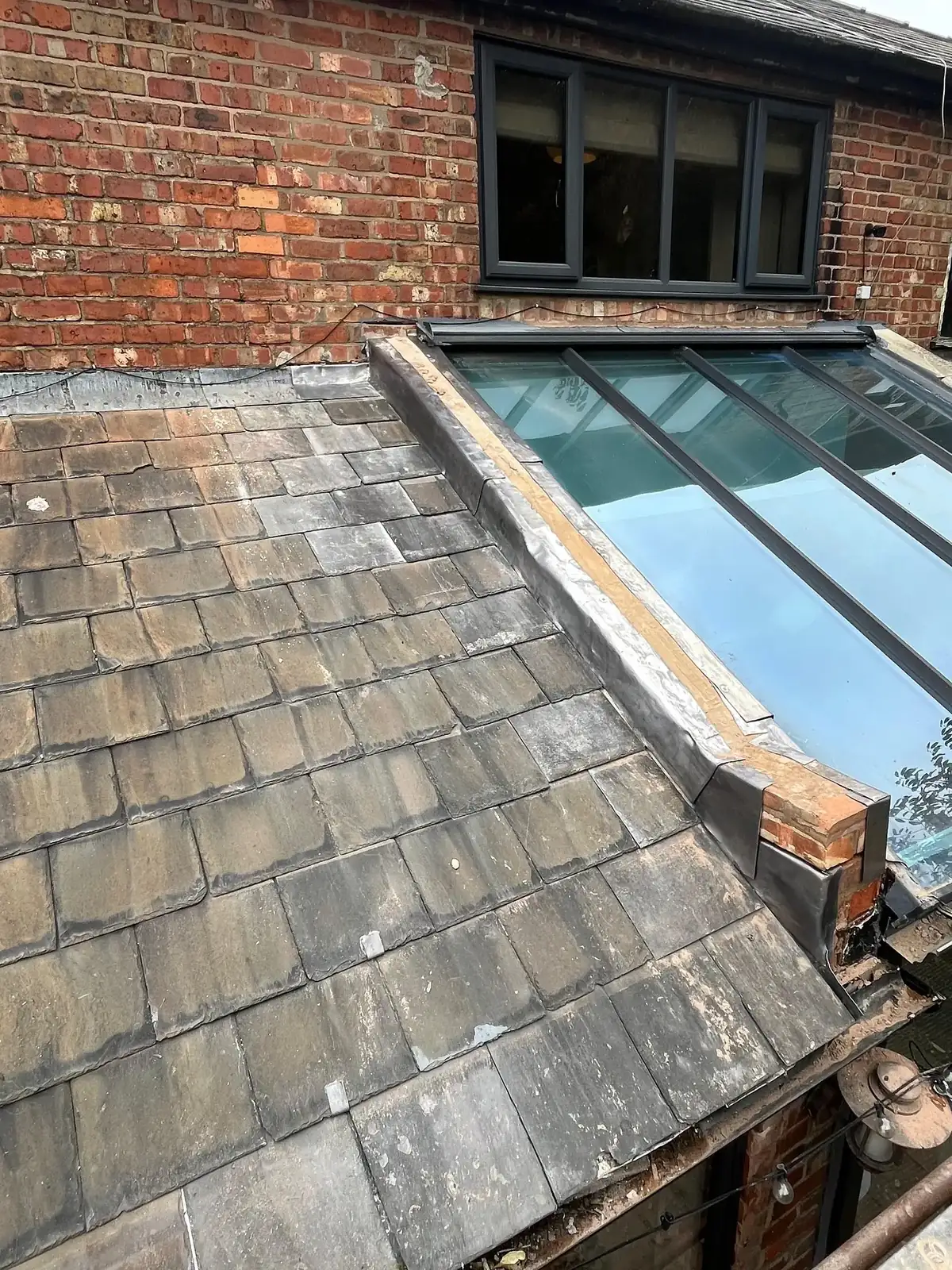 New glazed roof lantern set into an existing slate roof