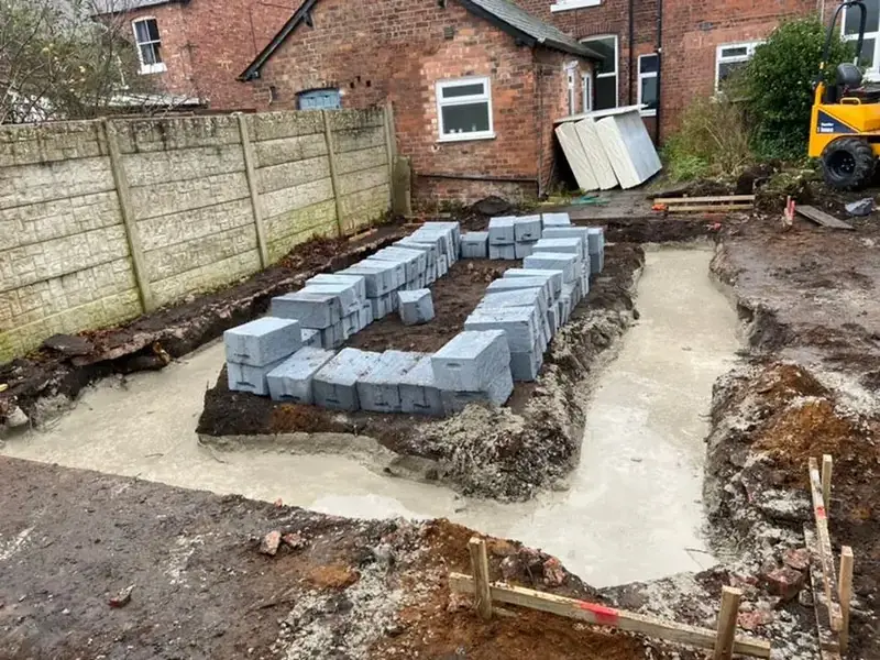 Foundation trenches excavated and concrete blocks set out ready for footings