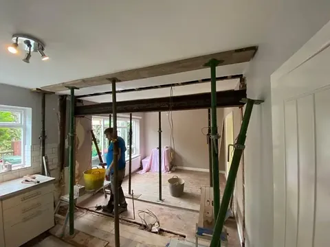 Internal structural opening formed with a new steel beam supported on acrow props