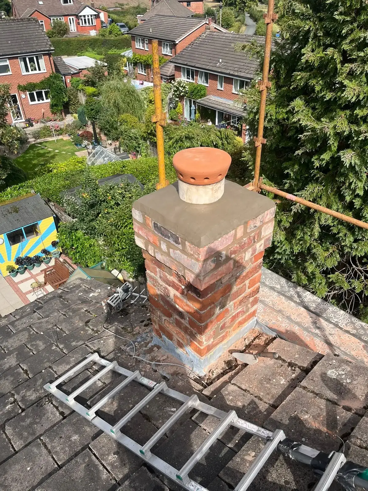 Chimney stack rebuilt in new brickwork with battens laid ready for tiling