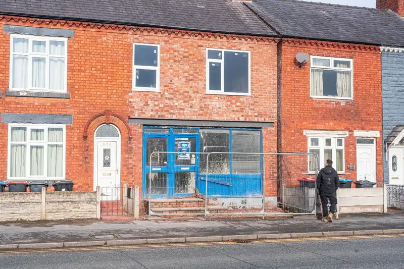 Red brick terrace under scaffold during external refurbishment work