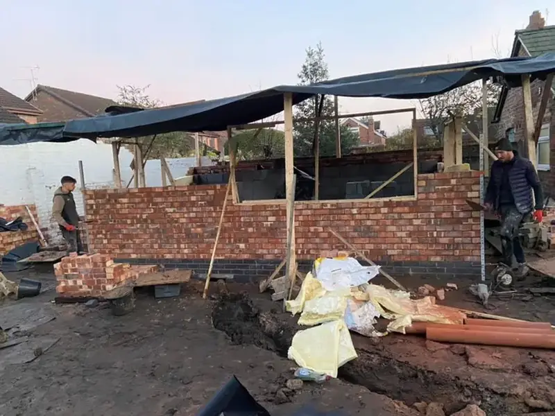 Brickwork protected by a temporary tarpaulin cover while work continues