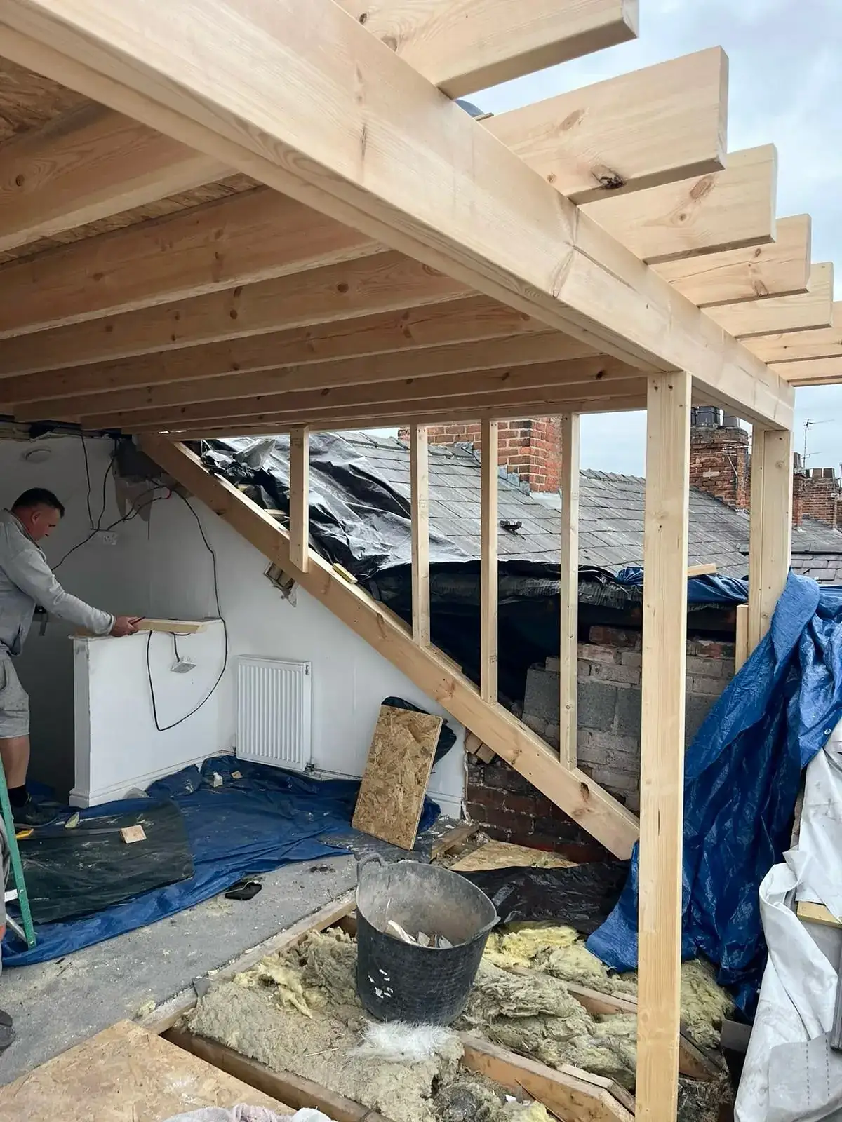 Loft opened up with new timber joists installed beneath a stripped roof